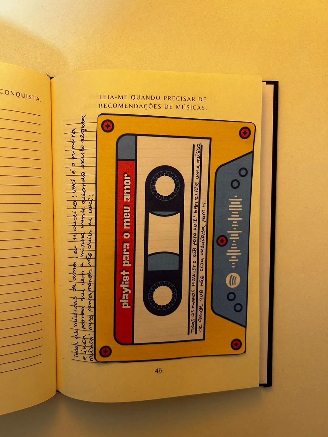 Página 46 do Leia-me quando preenchida, “Quando precisar de recomendações de músicas”: uma fita cassete de papel com a playlist do casal
